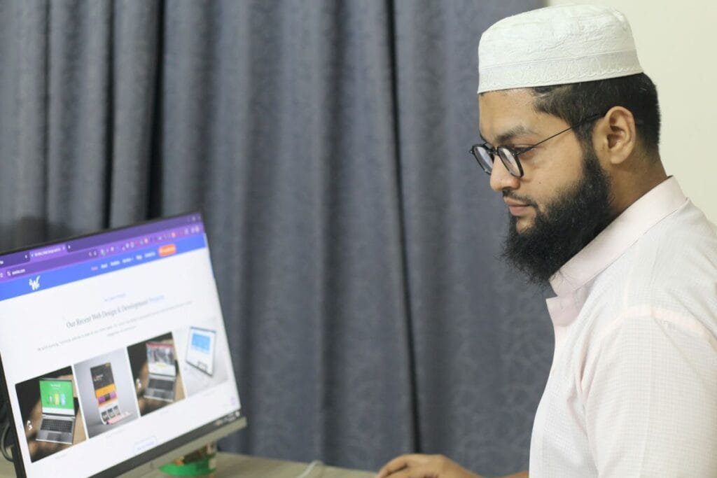 A website developer working on his computer from website development company
